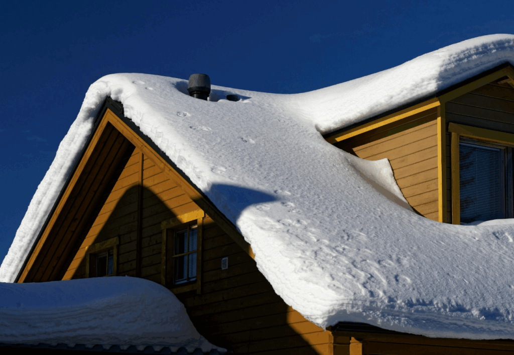 snow on top of a roof in the wintertime